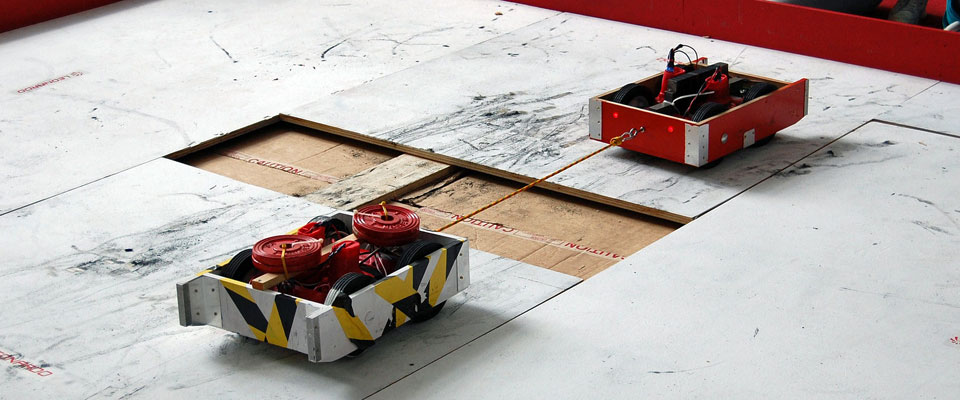 Two robots battle it out in the Rampaging Chariots tug of war