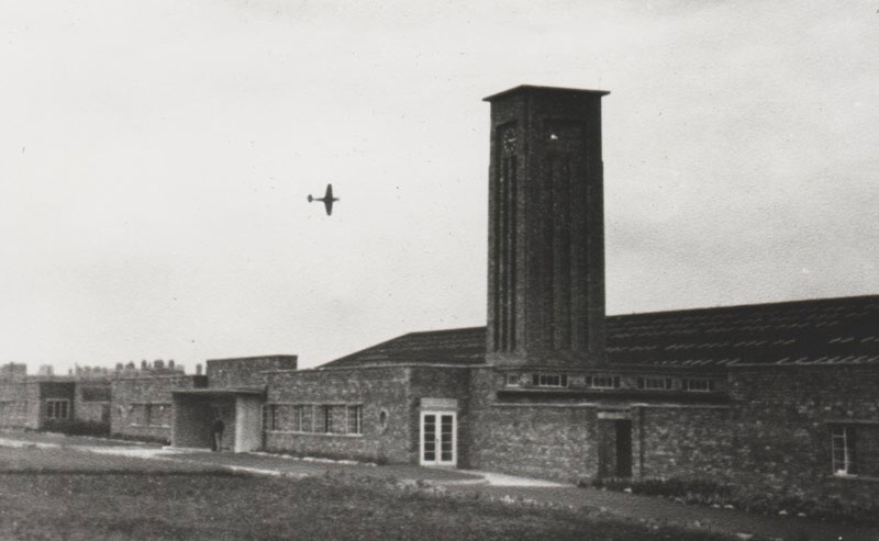 a Spitfire plane flies over the Crewe Toll in Edinburgh, during the 1940s